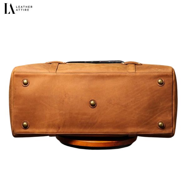 worn-leather-duffle-bag-with-brass-hardware